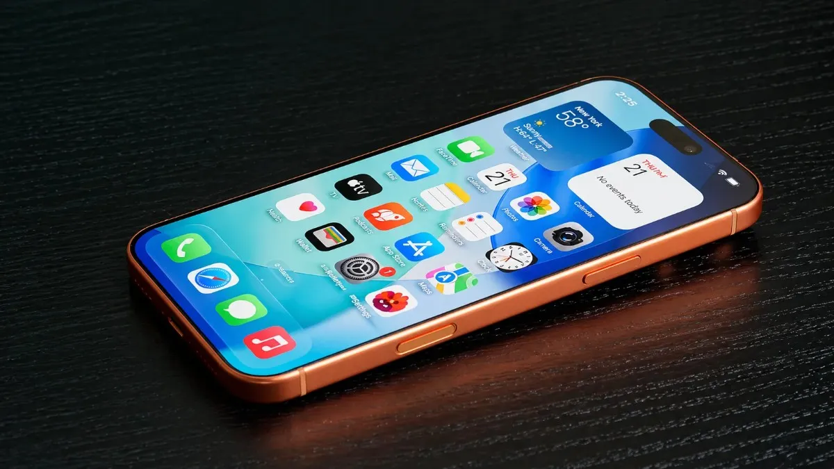 An Apple iPhone 18 Pro Max lying diagonally on a dark wooden table, showing a bright home screen with app icons and widgets, with a metallic frame and reflective lighting emphasizing a premium design.