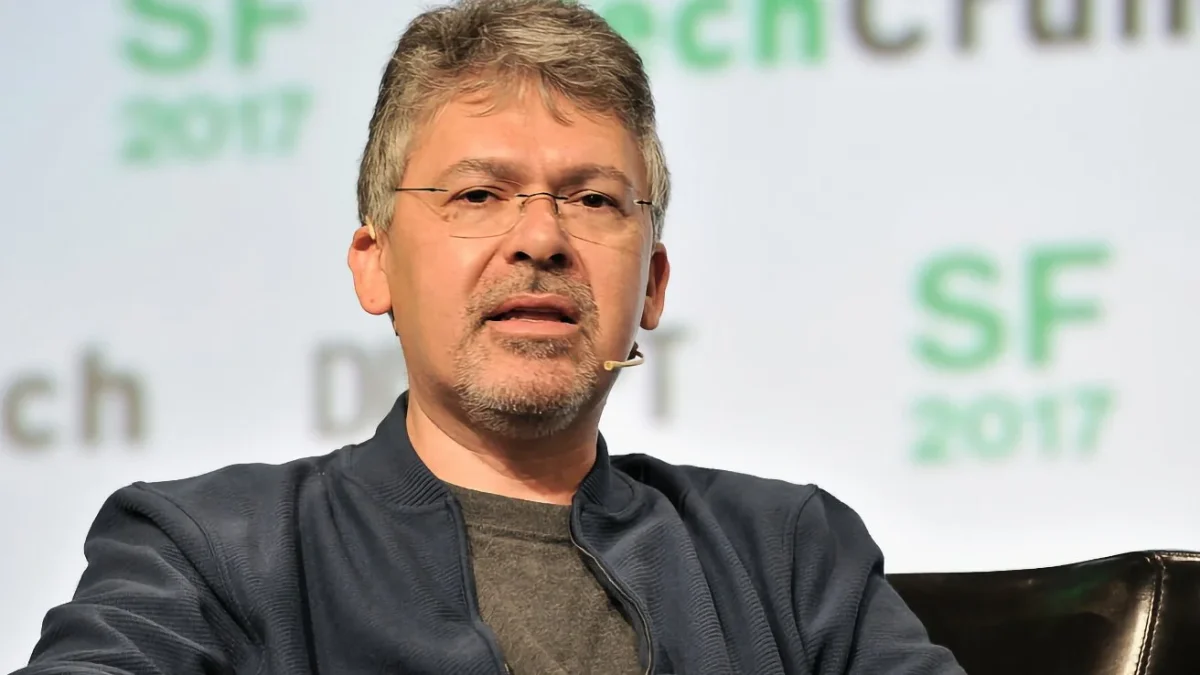 John Giannandrea Leaving Apple, former Apple Senior Vice President of Machine Learning and AI Strategy, speaking on stage at a tech conference.