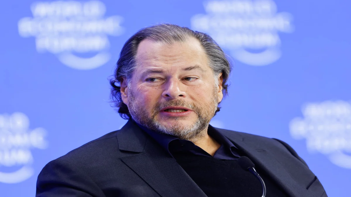 A close-up profile portrait of Salesforce Co-Founder and CEO Marc Benioff presenting on stage at a corporate technology conference.